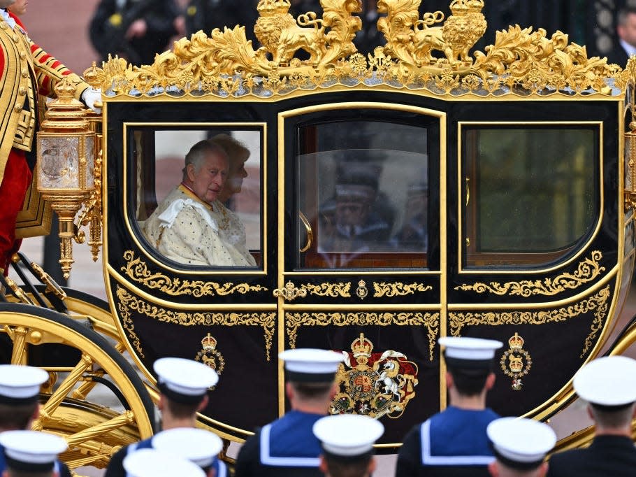 King Charles III traveling in the Diamond Jubilee Coach on route to Westminster Abbey for the Coronation of King Charles III and Queen Camilla on May 06, 2023 in London, England.