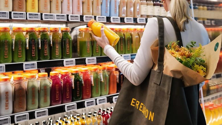 woman browsing juice selection at Erewhon
