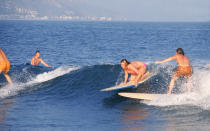 In 1968, Julian Wasser photographed these teenagers tackling the waves at Malibu Beach.