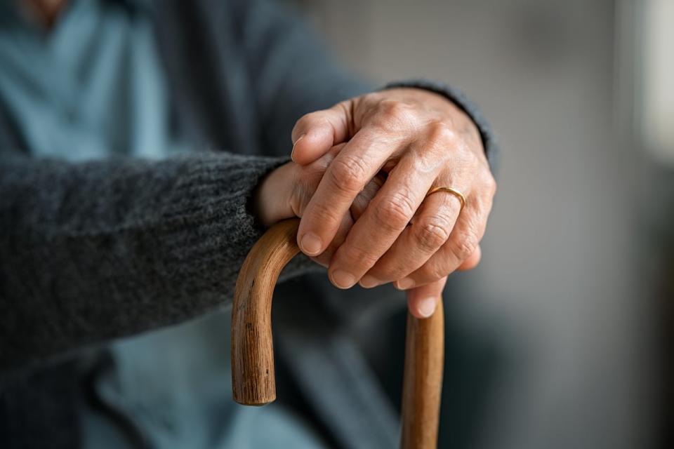 Close up of senior disabled woman hands holding walking stick. Detail of old woman hands holding handle of cane. Old lady holding walking stick. Stock Photo ID: 1889548966