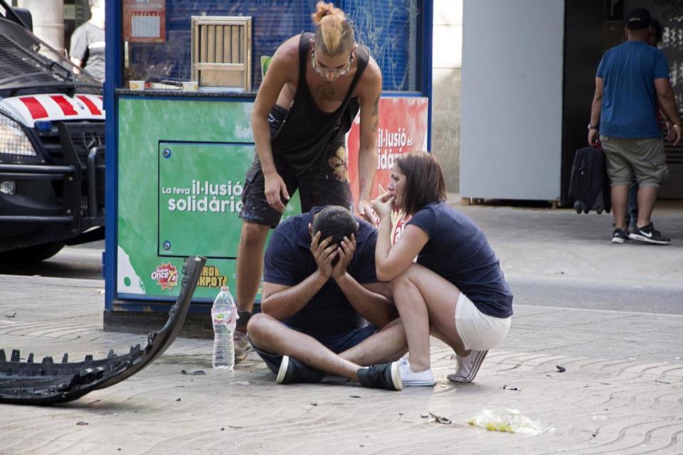 Distraught survivors at the scene of the attack in Barcelona (EPA)