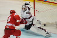 Poland's Krzysztof Macias, scores his side's third goal during the preliminary round match between Poland and Latvia at the Ice Hockey World Championships in Ostrava, Czech Republic, Saturday, May 11, 2024. (AP Photo/Darko Vojinovic)