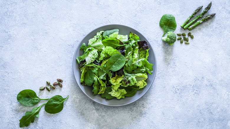 salad greens in white bowl