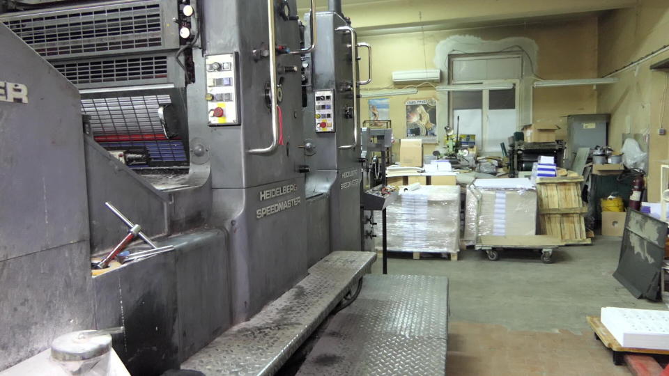 In this photo provided by Bulgaria's Interior Ministry on Tuesday, March 16, 2021, the interior a printing office in a university, in Sofia. Bulgarian authorities say they have seized high-quality forged banknotes produced at a printing office in a university in the Bulgarian capital. In a joint operation with U.S. Secret Service, Bulgarian police detained two people and seized a printing machine and equipment for printing money, along with large amounts of counterfeit U.S. dollar and euro notes. (Bulgarian Interior Ministry via AP)