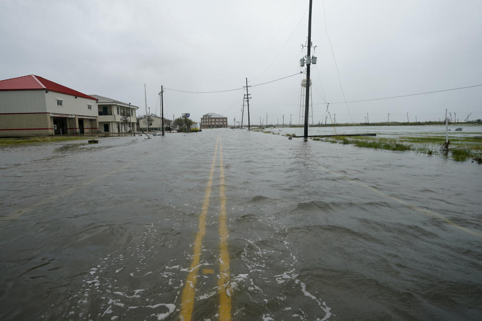 Water flows down a flooded street Friday, Aug. 28, 2020, in Cameron, La., after Hurricane Laura moved through the area Thursday. (AP Photo/David J. Phillip)