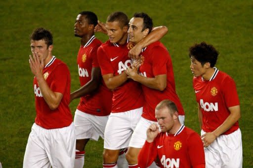 Dimitar Berbatov (C; right) of the Manchester United celebrates his goal against the MLS All-Stars with teammate Nemanja Vidic during their game at Red Bull Arena in Harrison, New Jersey. Manchester United won 4-0