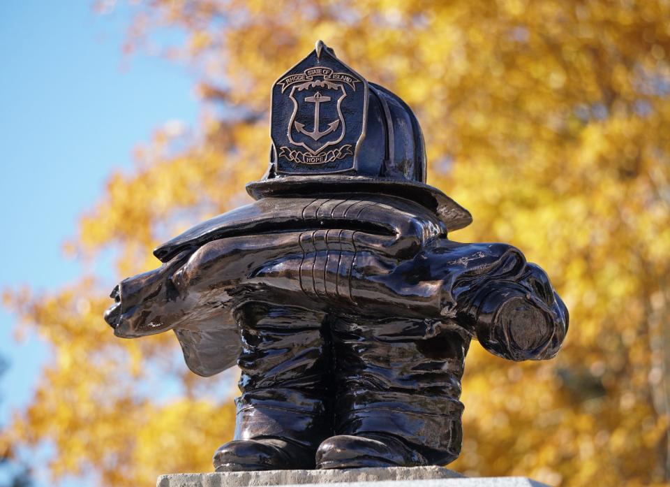 A bronze statue atop the main granite monument at the Rhode Island Firefighters Memorial in Exeter.