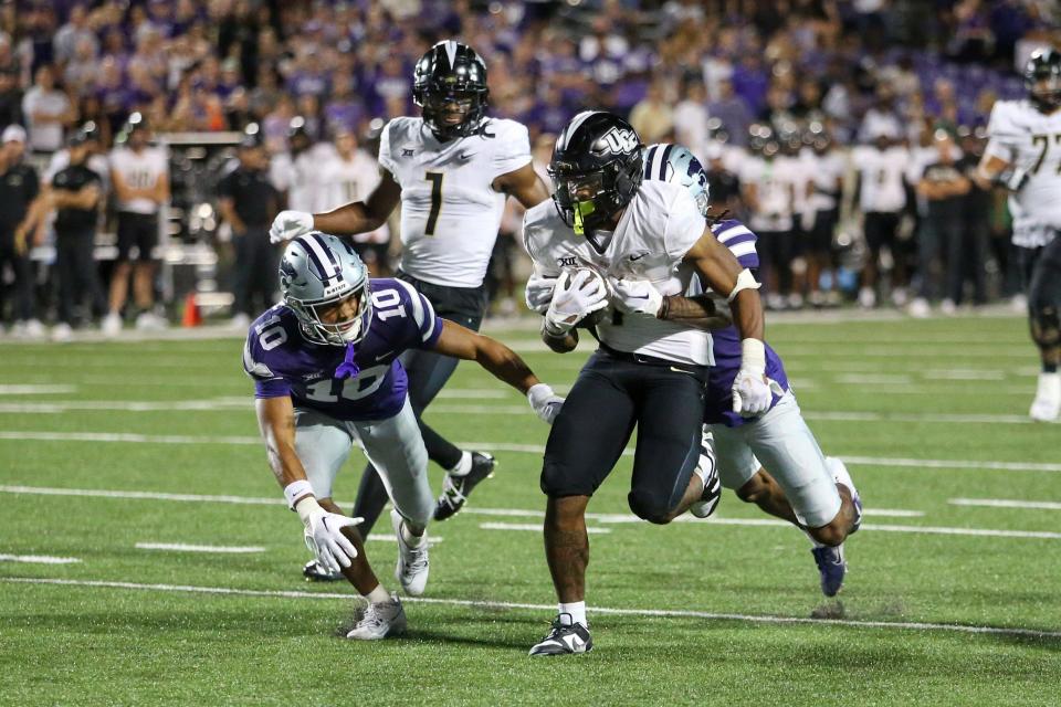 Sep 23, 2023; Manhattan, Kansas, USA; UCF Knights running back RJ Harvey (7) is stopped just short of the goal line by Kansas State Wildcats cornerback Will Lee III (8) and cornerback Jacob Parrish (10) during the fourth quarter at Bill Snyder Family Football Stadium. Mandatory Credit: Scott Sewell-USA TODAY Sports