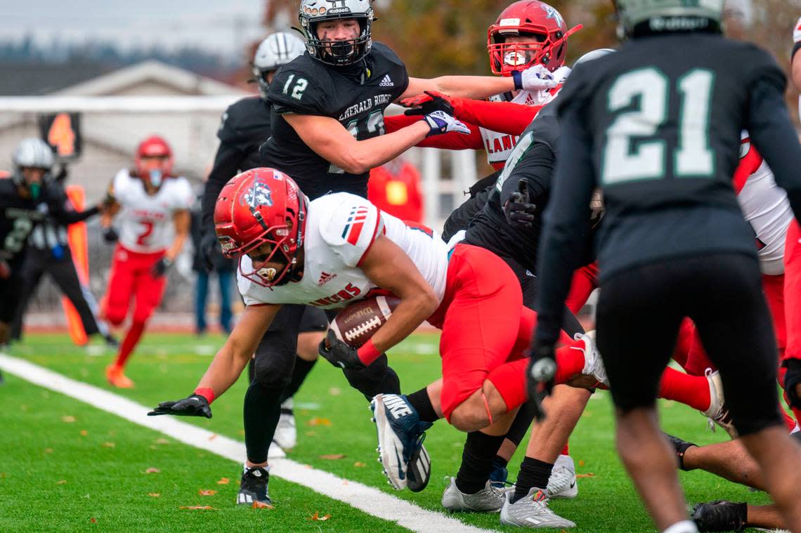 Kennedy Catholic running back Xe’Ree Alexander dives through the Emerald Ridge defensive line and into the endzone for a touchdown in the first quarter of a Class 4A state semifinal game on Saturday, Nov. 26, 2022, at Sparks Stadium in Puyallup, Wash.