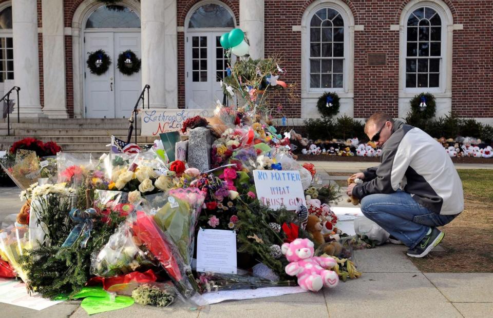 PHOTO: Erik Johannsen of Dover, Maryland, places stuffed animals at a memorial on December 24, 2012, to honor the 26 people killed in the Sandy Hook Elementary School shooting in Newtown, Conn.  (Hartford Courant/Tribune News Service via Getty Images)