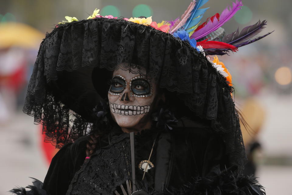 A woman dressed as a Catrina participates in the Day of the Dead parade in Mexico City, Saturday, Nov. 2, 2019. (AP Photo/Ginnette Riquelme)