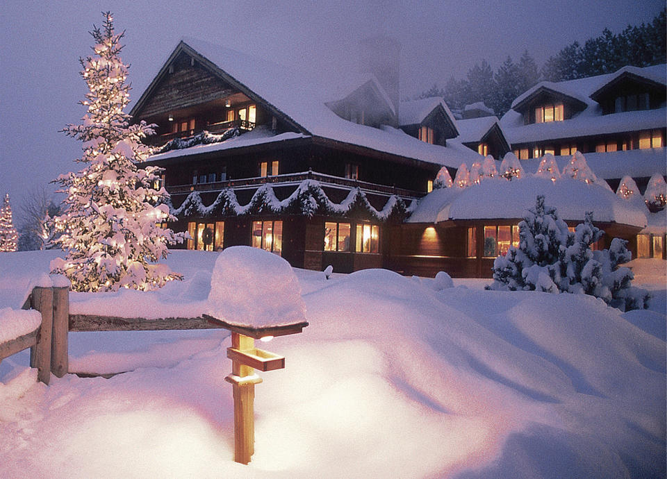 FILE - This 2004 file photo provided by the Trapp Family Lodge shows the Trapp Family Lodge in Stowe, Vt., lit up for the Christmas holidays. After a televised update of "The Sound of Music" on Dec. 5, 2013, the hills of Vermont were alive with phones ringing at the lodge. Three-quarters of a century after the singing family arrived from Austria, they're still in demand at the 96-room chalet style inn they started. The family moved to the spot in 1942 after visiting Vermont on a singing tour and vacationing in Stowe. (AP Photo/Trapp Family Lodge, Don Landwehrle, File)