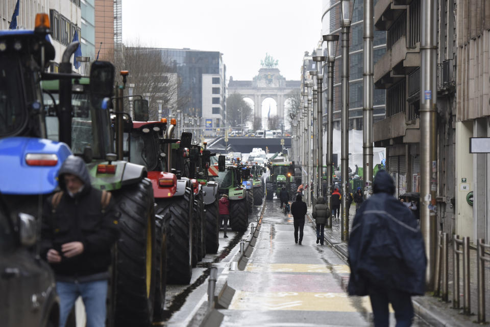 Tractors are parked on a main street during a farmers demonstration in the European Quarter outside a meeting of EU agriculture ministers in Brussels, Monday, Feb. 26, 2024. European Union agriculture ministers meet in Brussels Monday to discuss rapid and structural responses to the crisis situation facing the agricultural sector. (AP Photo/Harry Nakos)