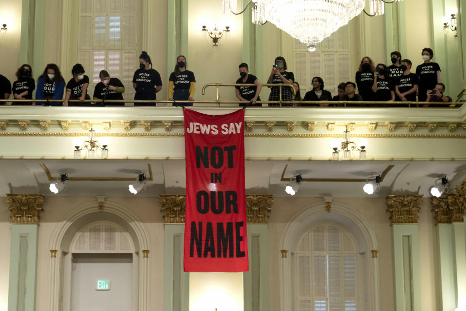 Protesters calling for a cease-fire in Gaza disrupt the first day of the California legislative session in Sacramento, Calif., Wednesday, Jan. 3, 2024. The Assembly session was just getting started when protesters wearing matching black t-shirts stood up in the gallery and started singing "Cease-fire now" and "Let Gaza Live." The Assembly adjourned the session.(AP Photo/Rich Pedroncelli)