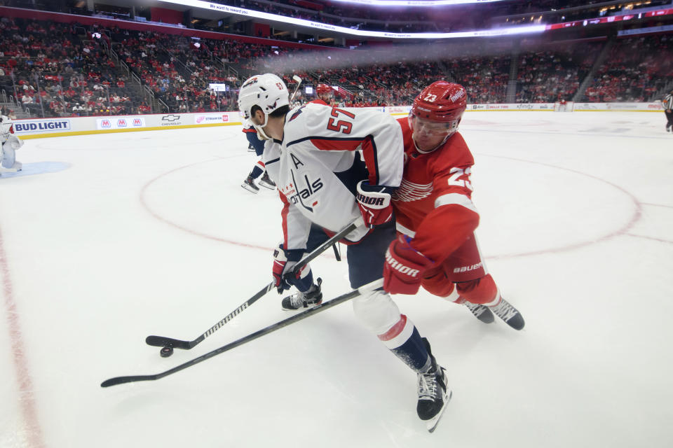 Detroit Red Wings left wing Lucas Raymond tries to steal the puck away from Washington Capitals defenseman Trevor van Riemsdyk during the first period of a preseason NHL hockey game Saturday, Sept. 30, 2023, in Detroit. (David Guralnick/Detroit News via AP)