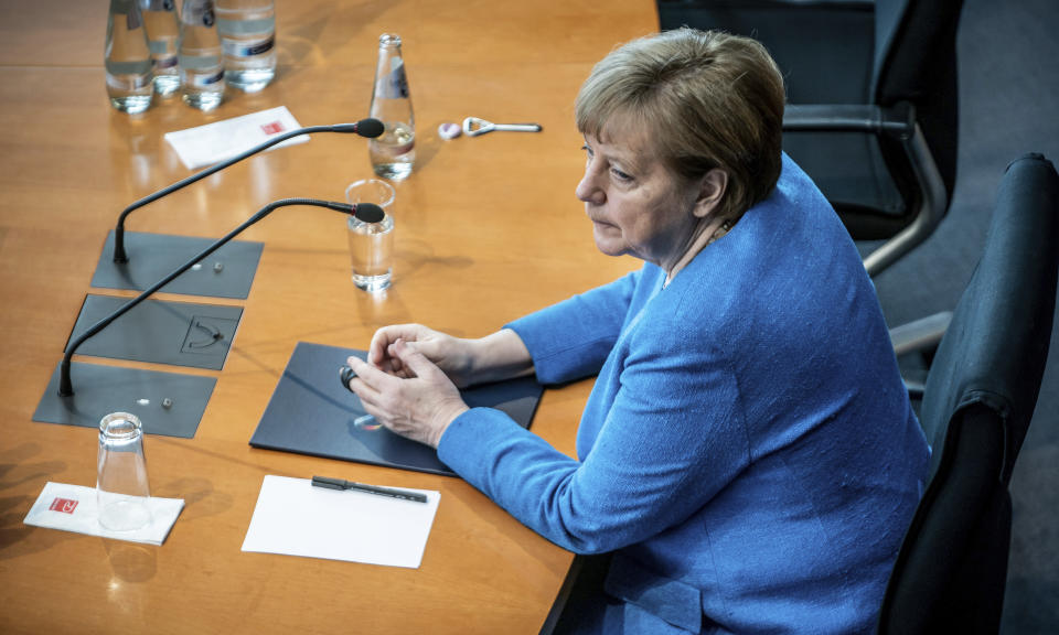 German Chancellor Angela Merkel arrives for the Wirecard investigation committee in Berlin, Germany, Friday, April 23, 2021. She has been summoned as a witness because she spoke up for Wirecard during a trip to China in September 2019. The 3rd Bundestag Investigative Committee is to investigate the conduct of the German government and the authorities under it in connection with the events surrounding the now insolvent financial services provider Wirecard. (Michael Kappeler/AP via Pool)