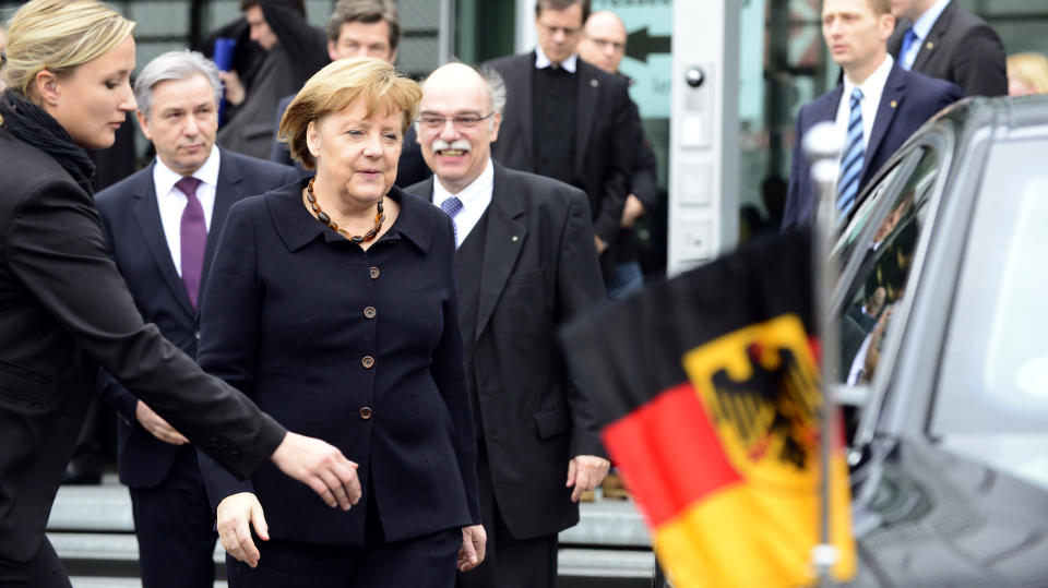 German Chancellor Angela Merkel (3rd L) leaves after the opening of the exhibition 'Berlin 1933 On the Path to Dictatorship', tracing Adolf Hitler's rise to power in Germany in 1933 to mark 80 years since he became chancellor, on January 30, 2013 at the open-air documentation center Topographie des Terrors in Berlin. (JOHN MACDOUGALL/AFP/Getty Images)