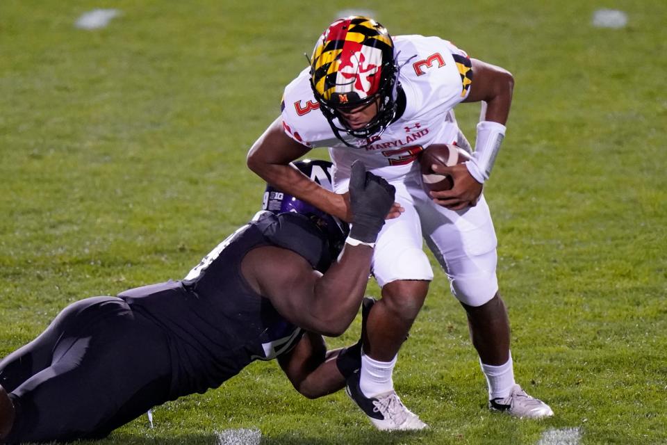 Maryland quarterback Taulia Tagovailoa is sacked by Northwestern defensive line Adetomiwa Adebawore during the second half of an NCAA college football game in Evanston, Ill., Saturday, Oct. 24, 2020. (AP Photo/Nam Y. Huh)
