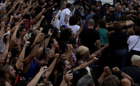 Demonstrators react during the wake as the coffin of Rio de Janeiro's city councillor Marielle Franco, 38, who was shot dead, arrives at the city council chamber in Rio de Janeiro, Brazil March 15, 2018. REUTERS/Ricardo Moraes