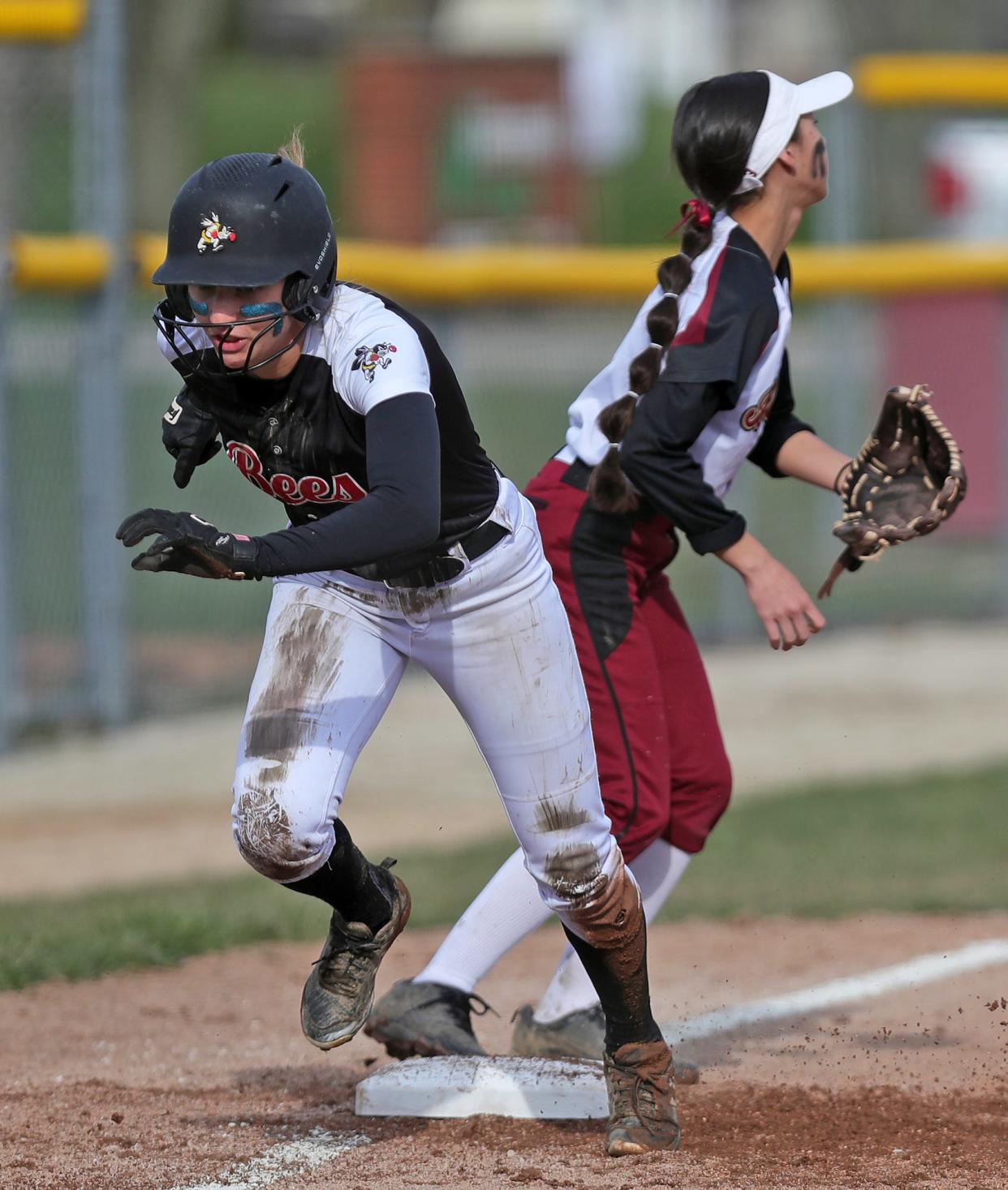 Brecksville baserunner Chelsea Mack, left, sprints home after stealing third during the first inning of a softball game against the Stow Bulldogs on Wednesday.