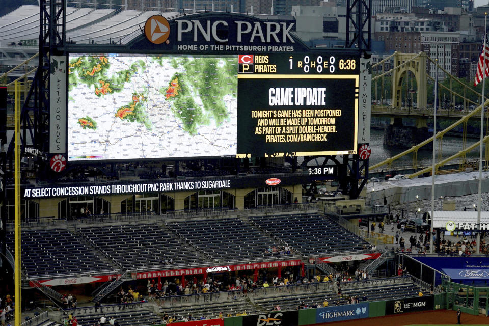 Fans begin to leave PNC Park after it was announced that the baseball game between the Pittsburgh Pirates and the Cincinnati Reds had been postponed due to inclement weather, Saturday, Aug. 12, 2023, in Pittsburgh. (AP Photo/Matt Freed)