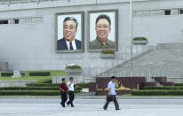 <p>In this image made from video, pedestrians walk beneath portraits of Kim Il Sung, left, and Kim Jong Il at Kim Il Sung square in Pyongyang, North Korea, Friday, Aug. 11, 2017. Despite tensions and talk of war, life on the streets of the North Korean capital Pyongyang remained calm. (AP Photo) </p>