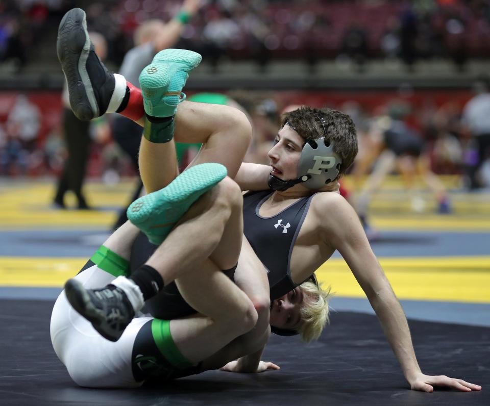 Emeric McBurney of Massillon Perry, top, is rolled over by Brody Palm of Harrison during their 106-pound match in the OHSAA State Wrestling Tournament at the Jerome Schottenstein Center, Friday, March 10, 2023, in Columbus, Ohio. McBurney eventually pinned Palm with a second remaining.