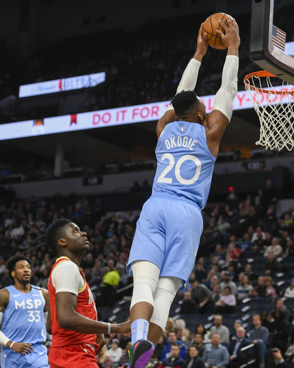 Minnesota Timberwolves guard Josh Okogie (20) dunks the ball as Houston Rockets center Clint Capela looks on during the first half of an NBA basketball game Friday, Jan. 24, 2020, in Minneapolis. (AP Photo/Craig Lassig)