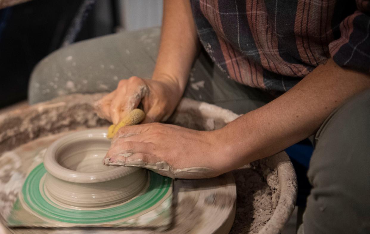 Rachel Whisler works on a pottery piece on her pottery wheel in her garage studio in Dickson, Tenn., Tuesday, Nov. 14, 2023.
