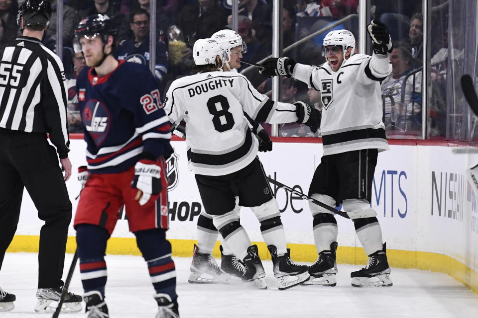 Los Angeles Kings' Anze Kopitar celebrates his goal against the Winnipeg Jets with Drew Doughty (8)during the second period of an NHL hockey game in Winnipeg, Manitoba, on Tuesday, Feb. 28, 2023. (Fred Greenslade/The Canadian Press via AP)