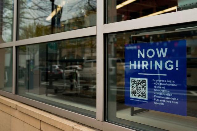 A hiring sign in the window of a shuttered 2nd Time Around