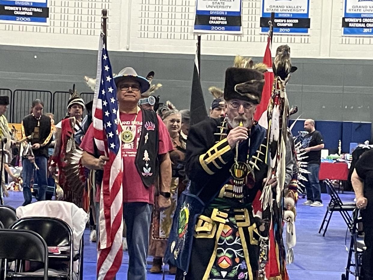 Former Pokagon Band of Potawatomi Chairman John Warren carried the American flag behind Dan Bissell to lead the Grand Entry. (Photographs by Levi Rickert for Native News Online)