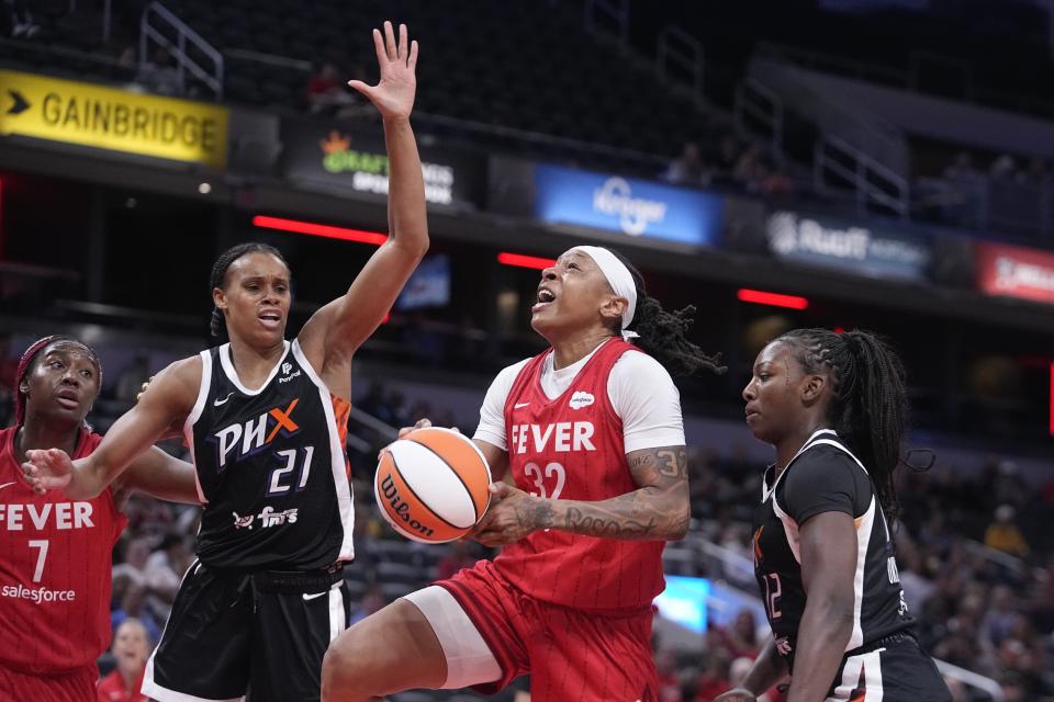 Indiana Fever's Emma Cannon (32) shoots against Phoenix Mercury's Brianna Turner (21) and Michaela Onyenwere during the first half of a WNBA basketball game, Tuesday, Aug. 1, 2023, in Indianapolis. (AP Photo/Darron Cummings)