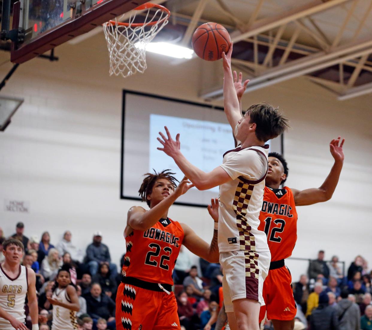 Brandywine senior Byron Linley puts up a layup over two Dowagiac defenders during a boys basketball game Tuesday, Jan. 9, 2024, at Brandywine High School in Niles.