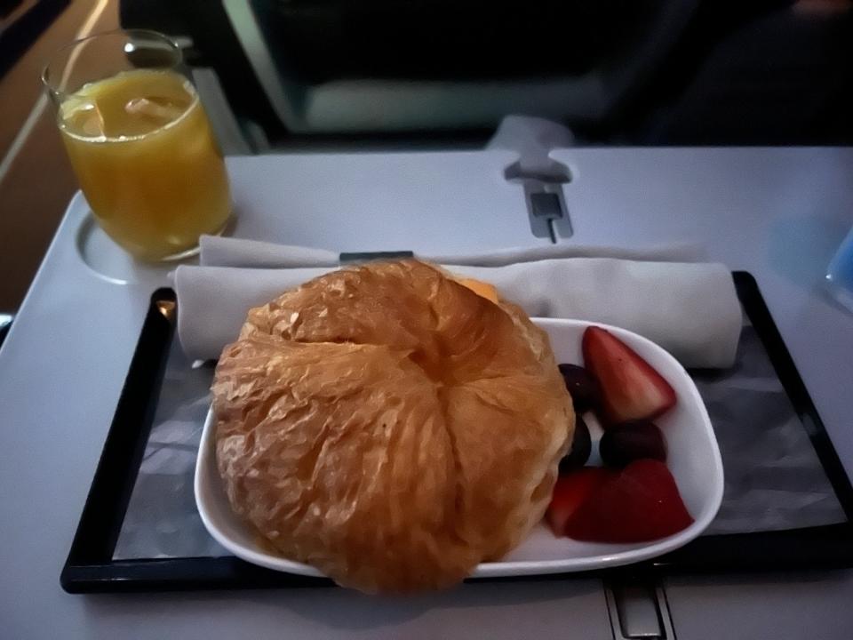 croissant, berries, orange juice on icelandair breakfast