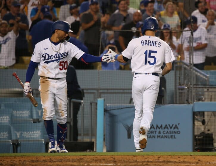 LOS ANGELES, CA - AUGUST 24: Austin Barnes gets congratulated by Mookie Betts following his two-run homerun in the sixth inning against the Milwaukee Brewers at Dodger Stadium on Wednesday, Aug. 24, 2022 in Los Angeles, CA. (Myung J. Chun / Los Angeles Times)