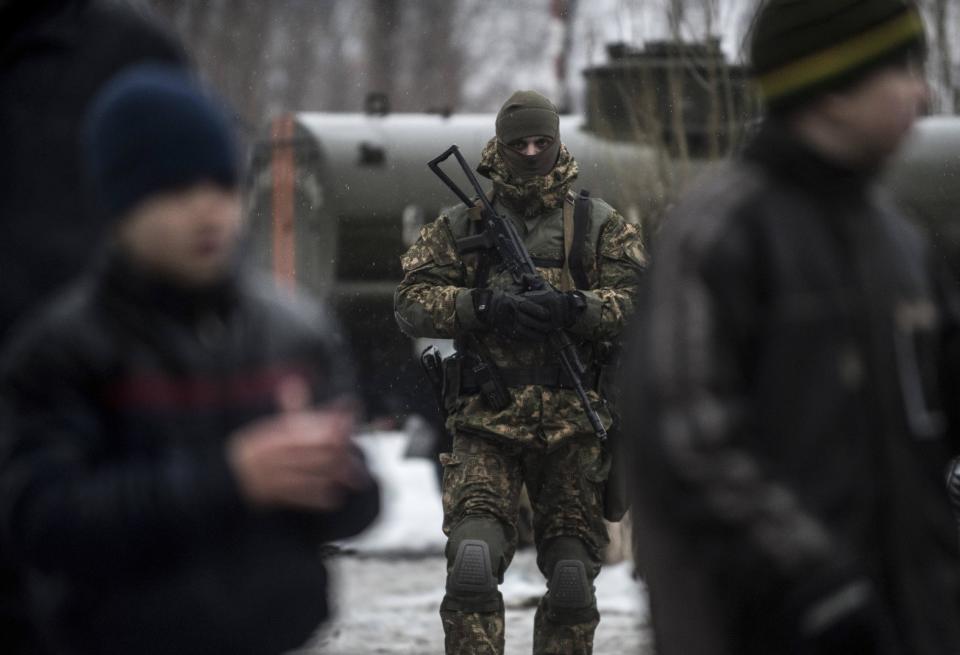 A Ukrainian serviceman patrols at the humanitarian aid center in Avdiivka, Ukraine, Saturday, Feb. 4, 2017. Fighting in eastern Ukraine sharply escalated this week. Ukraine's military said several soldiers were killed over the past day in shelling in eastern Ukraine, where fighting has escalated over the past week. (AP Photo/Evgeniy Maloletka)