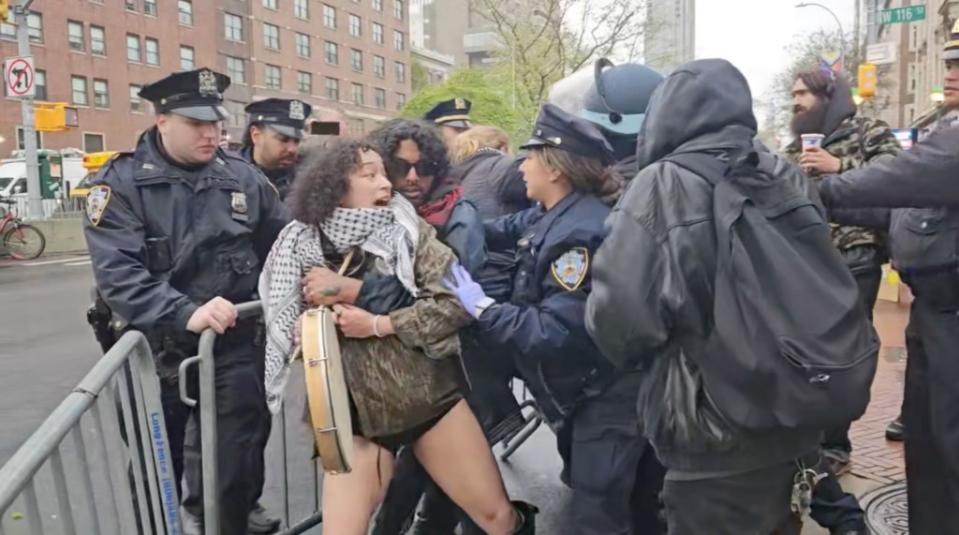 Multiple people wearing Palestinian keffiyehs were seen being grabbed by NYPD officers who appeared to be holding zip ties or other restraints, the footage showed. Jon farina / Status Coup News