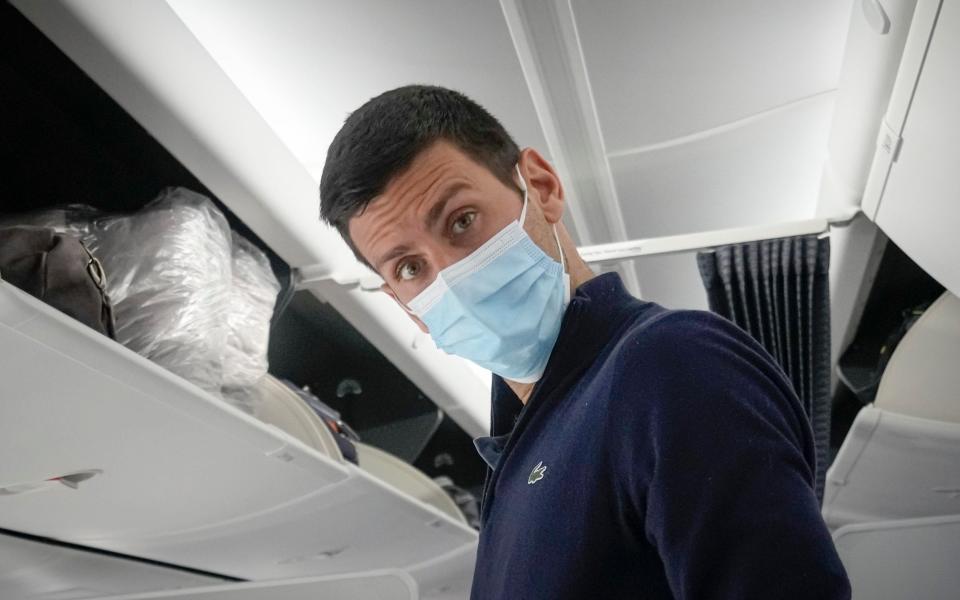 Novak Djokovic prepares to take his seat on a plane from Dubai to Belgrade - Darko Bandic /AP