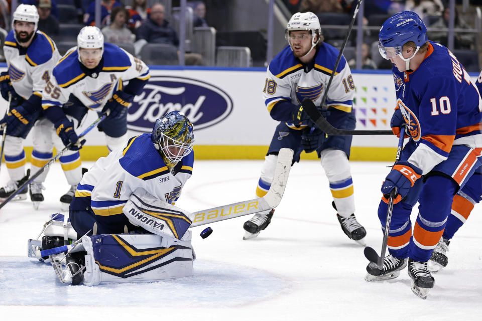 St. Louis Blues goaltender Thomas Greiss makes a save in front of New York Islanders right wing Simon Holmstrom (10) during the second period of an NHL hockey game Tuesday, Dec. 6, 2022, in Elmont, N.Y. (AP Photo/Adam Hunger)