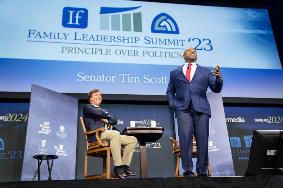 Tucker Carlson interviews GOP presidential candidate Sen. Tim Scott, R-S.C. during the Family Leadership Summit in Des Moines, Friday, July 14, 2023. 