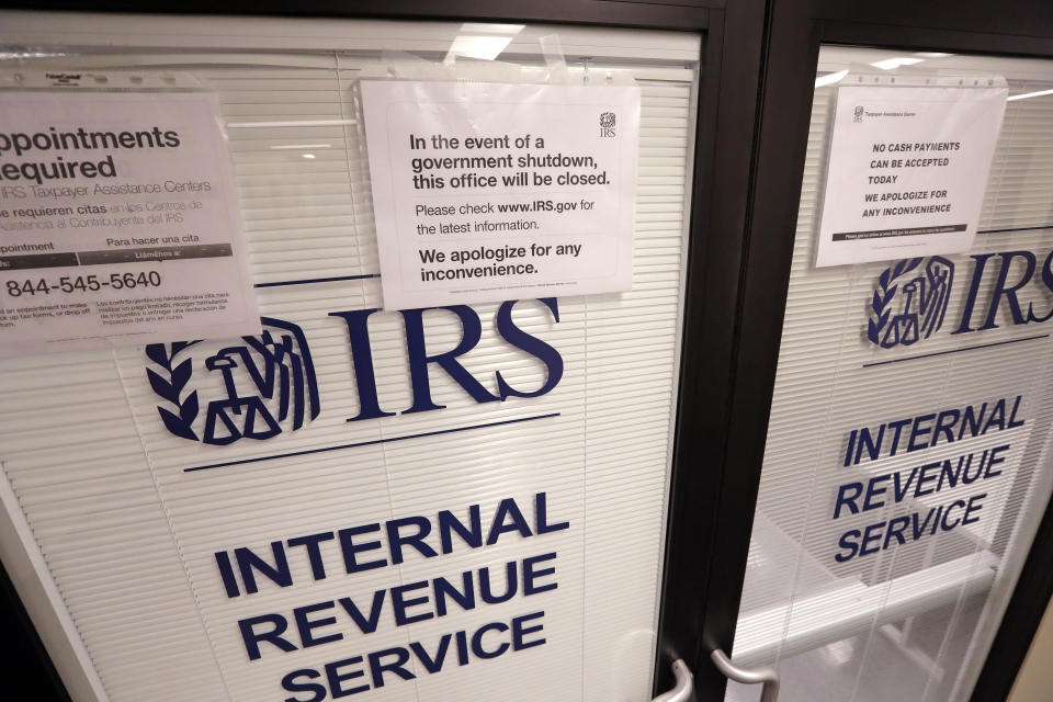 Doors at the Internal Revenue Service (IRS) in the Henry M. Jackson Federal Building are locked and covered with blinds as a sign posted advises that the office will be closed during the partial government shutdown Wednesday, Jan. 16, 2019, in Seattle. The shutdown is in its fourth week with no end in sight. (AP Photo/Elaine Thompson)