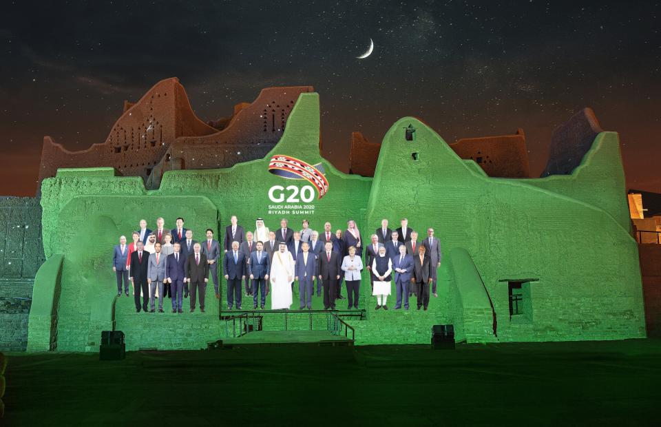 In this handout image provided by DGDA, Diriyah Gate Development Authority of Saudi, a family photo featuring members of the G20 is projected onto the walls of Salwa Palace, At Turaif on Saturday, Nov. 20, 2020 in Diriyah, on the outskirts of Riyadh, Saudi Arabia. (Meshari-Alharbi, DGDA via AP)