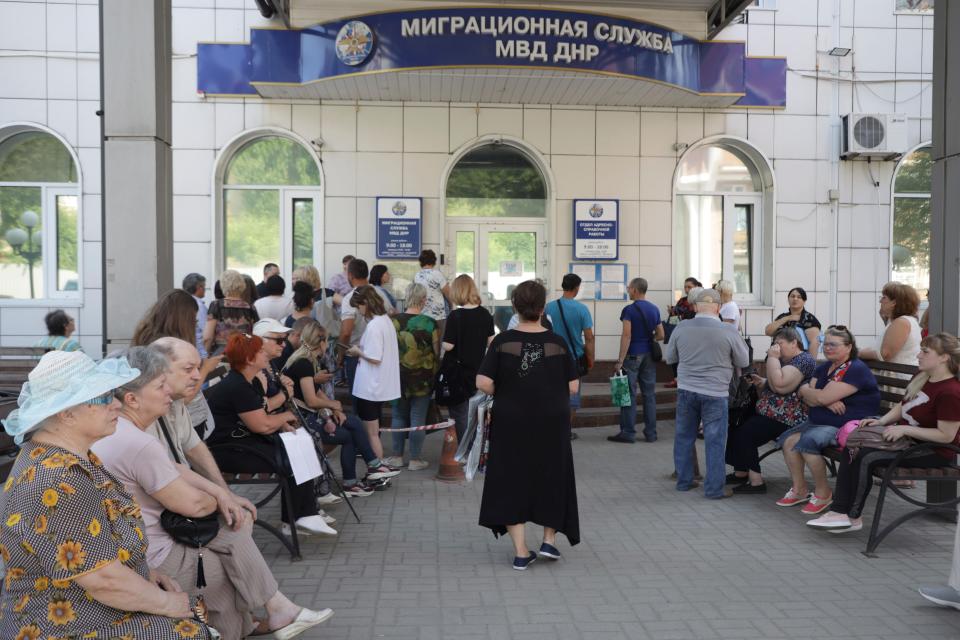 Residents of Donetsk stand in line at a Migration Service office to receive a passport of a citizen of the Russian Federation, in Donetsk, in an area controlled by Russian-backed separatist forces, eastern Ukraine, on July 5, 2022.