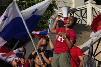 Protesters celebrate as they learn that Panama's Supreme Court has declared unconstitutional a 20-year concession for a Canadian copper mine that had sparked weeks of protests, in Panama City, Tuesday, Nov. 28, 2023. (AP Photo/Arnulfo Franco)