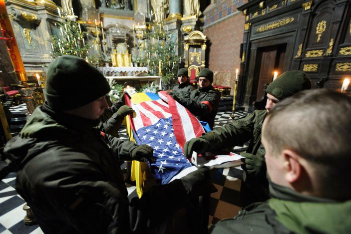 Ukrainians soldiers participate in the farewell ceremony for US citizen Daniel W. Swift in Lviv, Ukraine, Tuesday, Jan. 31, 2023.