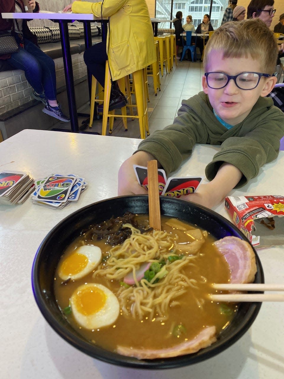 Donnelly Lane checks out the ramen while playing Uno at Zero Degrees.