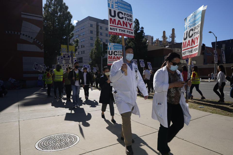 FILE - People participate in a protest outside the University of California Los Angeles campus in Los Angeles, Monday, Nov. 14, 2022. On Tuesday, Nov. 29, 2022, postdoctoral scholars and academic researchers reached a tentative labor agreement with the University of California but will remain on strike in solidarity with thousands of graduate student workers who remain on picket lines at all 10 UC campuses. (AP Photo/Damian Dovarganes, File)