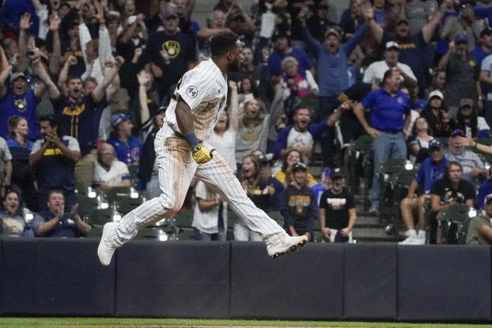 Milwaukee Brewers' Pablo Reyes scores reacts after scoring during the eighth inning of a baseball game against the Chicago Cubs Saturday, Sept. 18, 2021, in Milwaukee. Reyes scored on a hit by Kolten Wong. (AP Photo/Morry Gash)