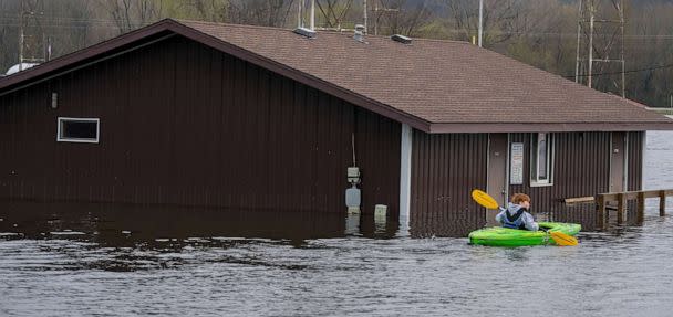 PHOTO: A kayaker paddles past a concession stand for a baseball field flooded by the Mississippi River, April 27, 2023, in Wabasha, Minn. (Mark Hoffman/Milwaukee Journal via USA Today Network)